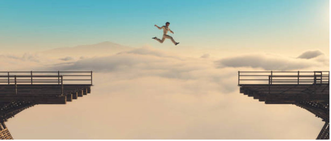 Person Jumping the gap of a bridge